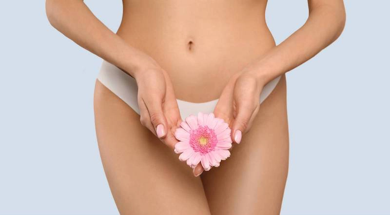 Labiaplasty patient holding a pretty flower